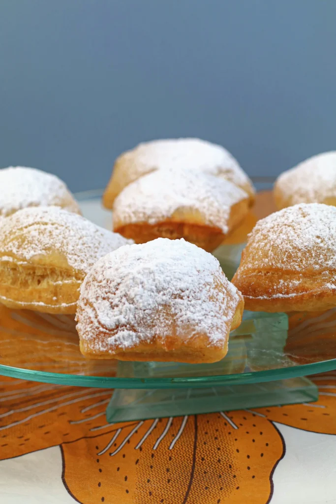 Freshly baked French Quarter style beignets covered in powdered sugar