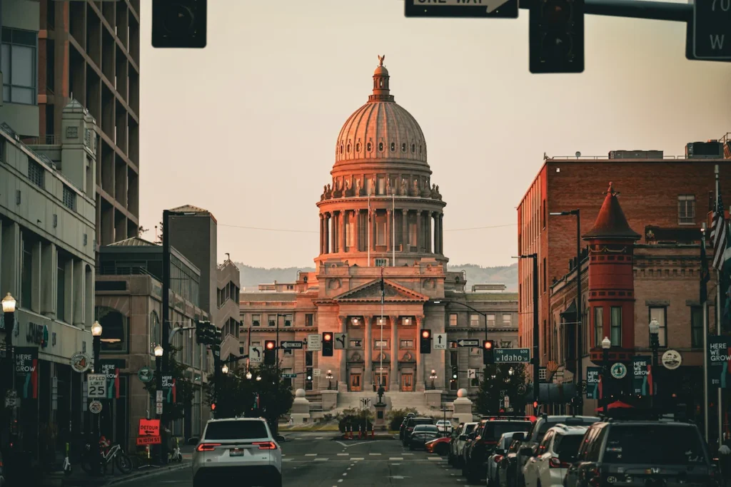 Idaho State Capitol dome viewed from a Boise street at sunset