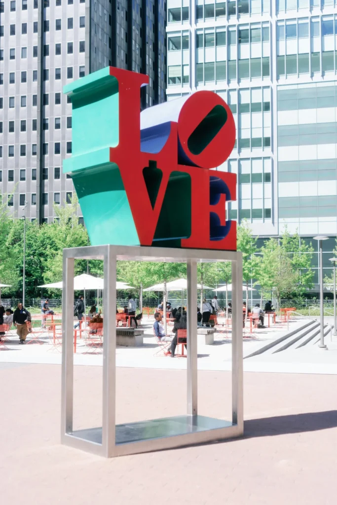 Robert Indiana's LOVE sculpture on a metal pedestal in Love Park