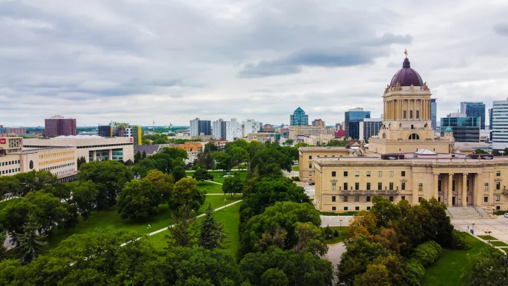Manitoba Legislative Building and surrounding park under cloudy skies