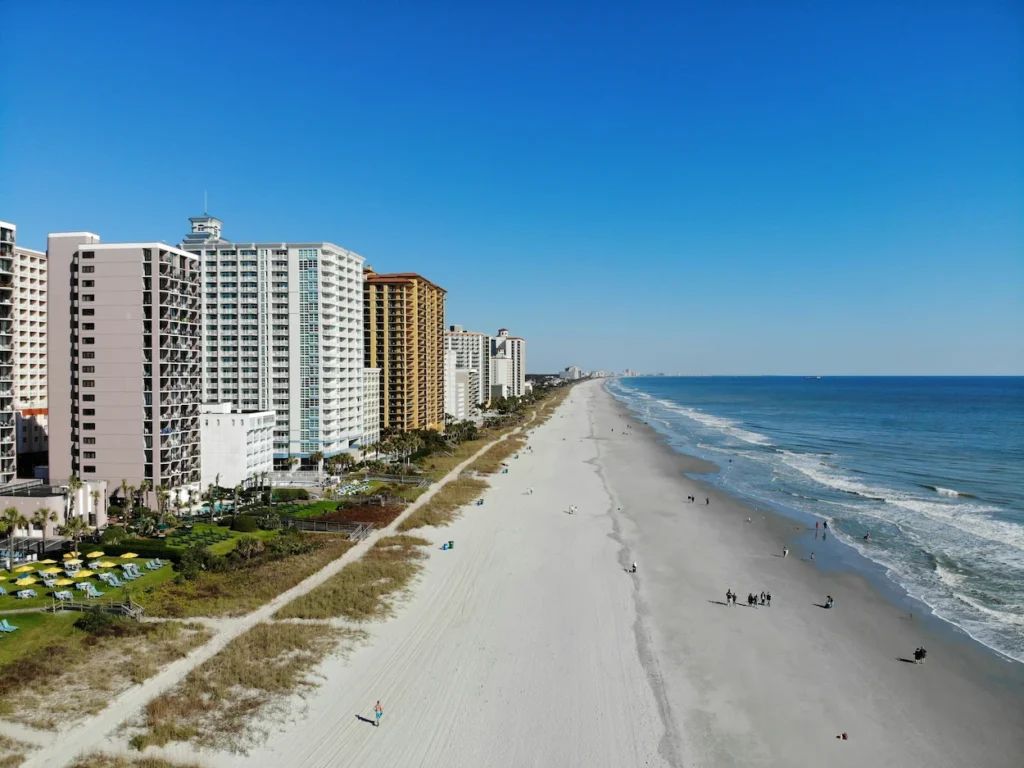 An aerial view of high-rise hotels lining the sandy coastline of Myrtle Beach