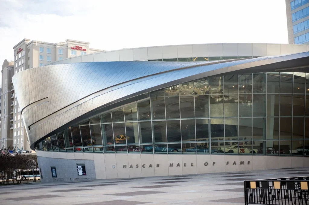 The curved silver exterior and glass facade of the NASCAR Hall of Fame