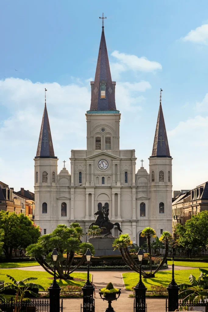 St. Louis Cathedral and Andrew Jackson statue in Jackson Square under a blue sky