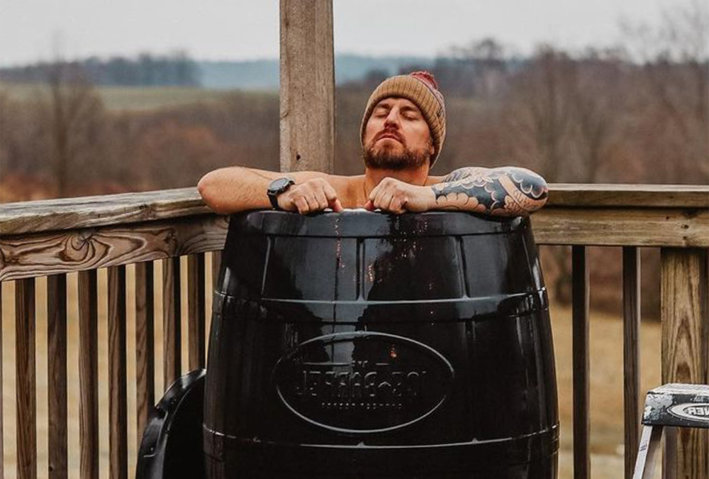 a man using this cold tub product on an outside deck