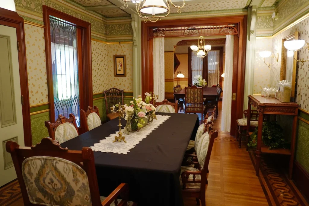 Victorian dining table and upholstered chairs inside the Winchester Mystery House