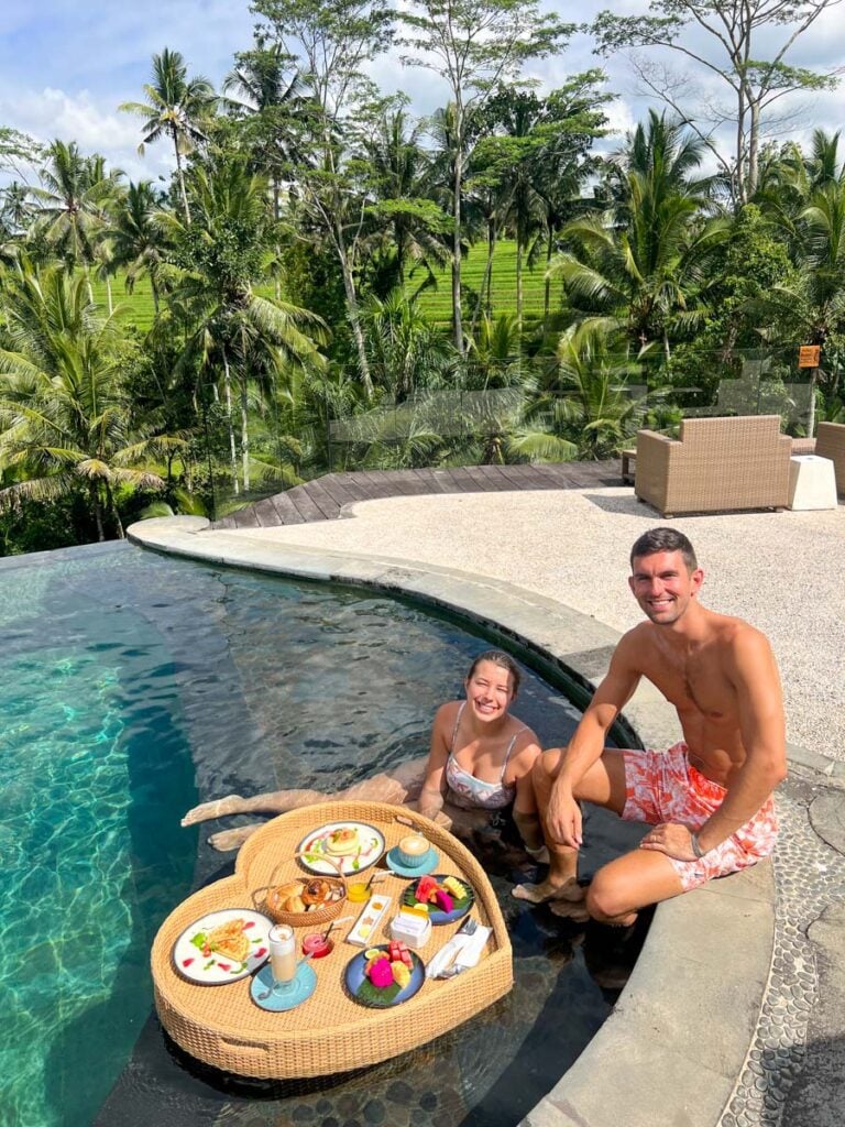 My photo of my wife and I in Bali eating a floating breakfast (super affordable)