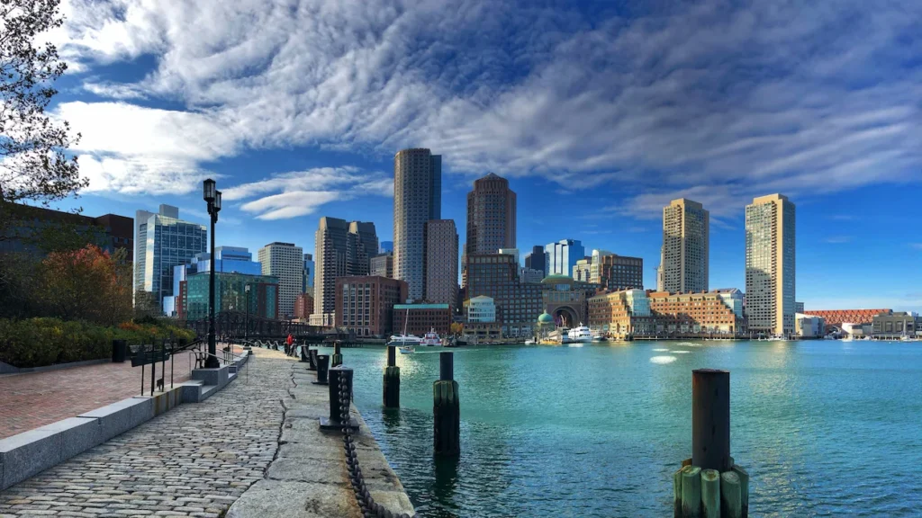 Modern skyscrapers lining the downtown Boston skyline seen from the Harborwalk