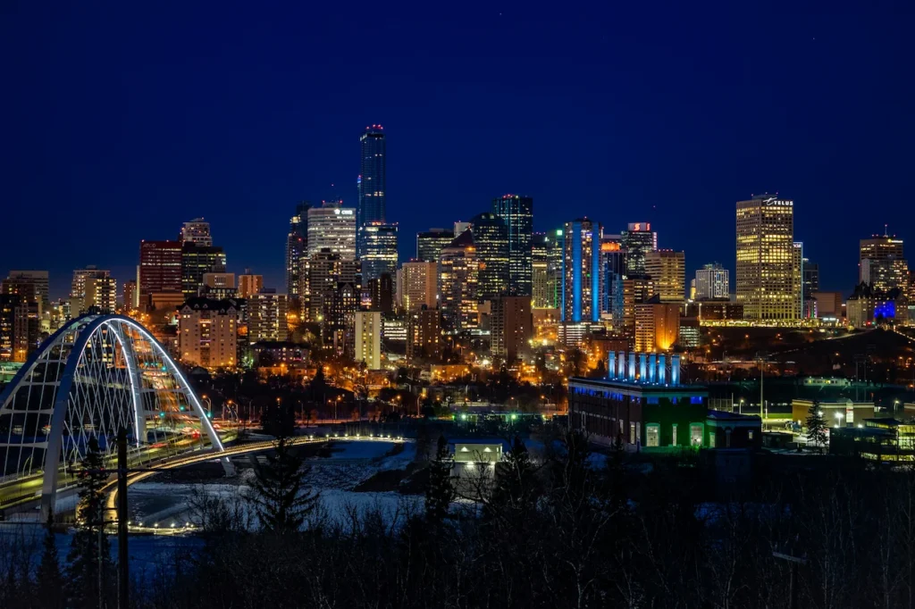 Edmonton skyline at night with the lit-up arches of the Walterdale Bridge