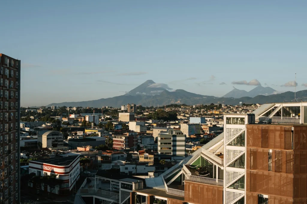 An elevated view of Guatemala City with Pacaya volcano rising in the background