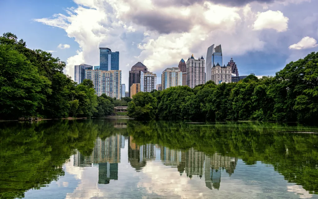 The Midtown Atlanta skyline reflecting perfectly on Lake Clara Meer in Piedmont Park