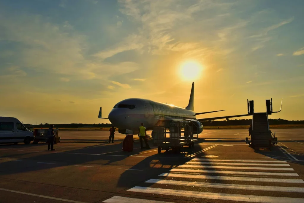 Transavia Boeing 737 passenger airplane parked on an airport tarmac during a bright sunset