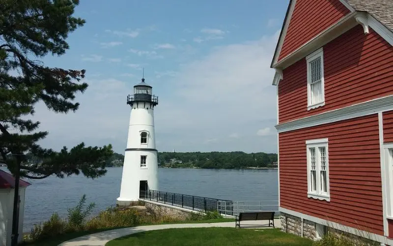 White lighthouse beside a red building on Rock Island.