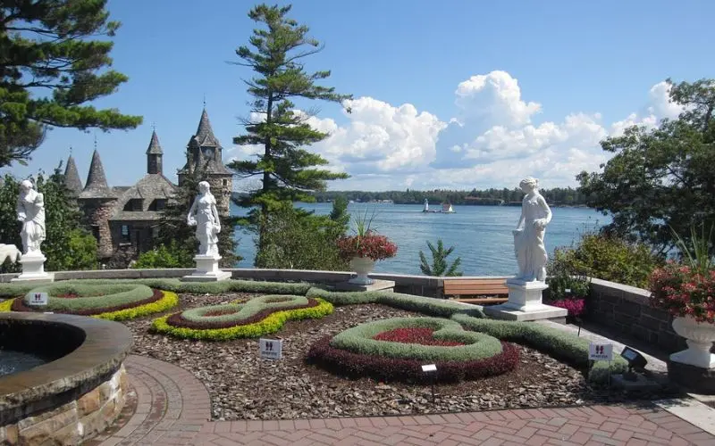 Formal gardens and statues overlooking the river at Heart Island.