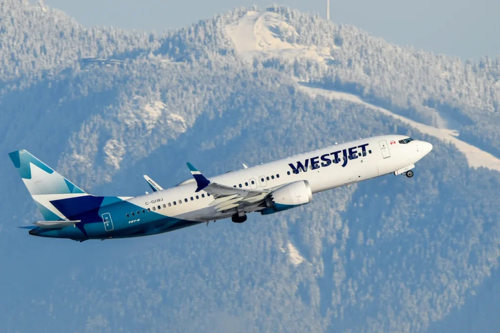 WestJet Boeing 737 MAX 8 passenger airplane registration C-GIWJ taking off