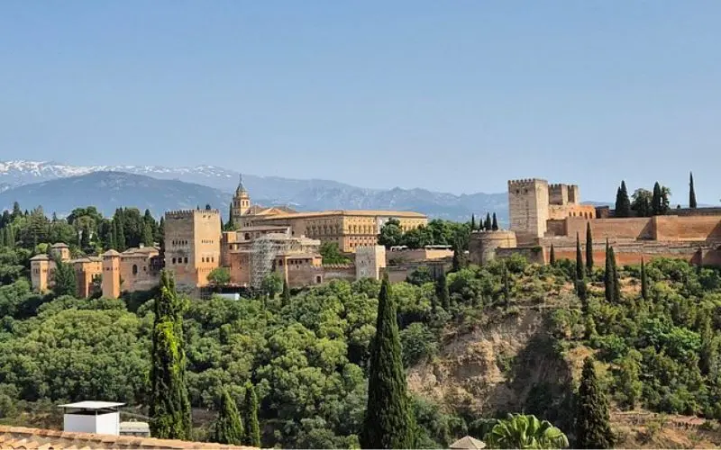 The Alhambra palace complex surrounded by greenery in Spain.