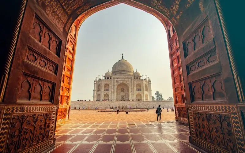 The Taj Mahal viewed through an ornate arch in India.