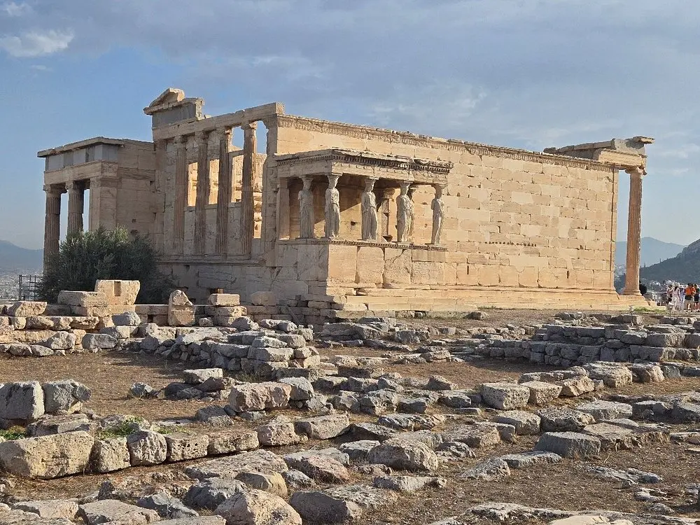 The ancient Erechtheion temple with stone columns at the Acropolis in Athens.