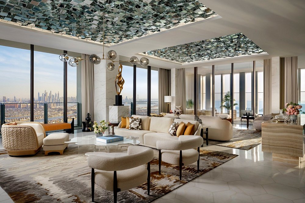 Atlantis The Royal suite with luxury modern decor, mirrored ceiling, and city views.