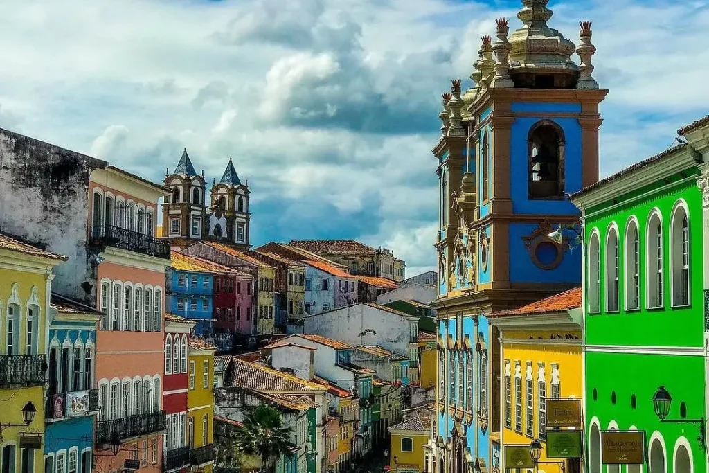 Colorful colonial buildings and a baroque church line the historic streets of Pelourinho in Salvador, Brazil.