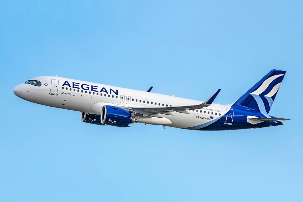 Aegean Airlines Airbus A320neo passenger airplane climbing into a clear blue sky