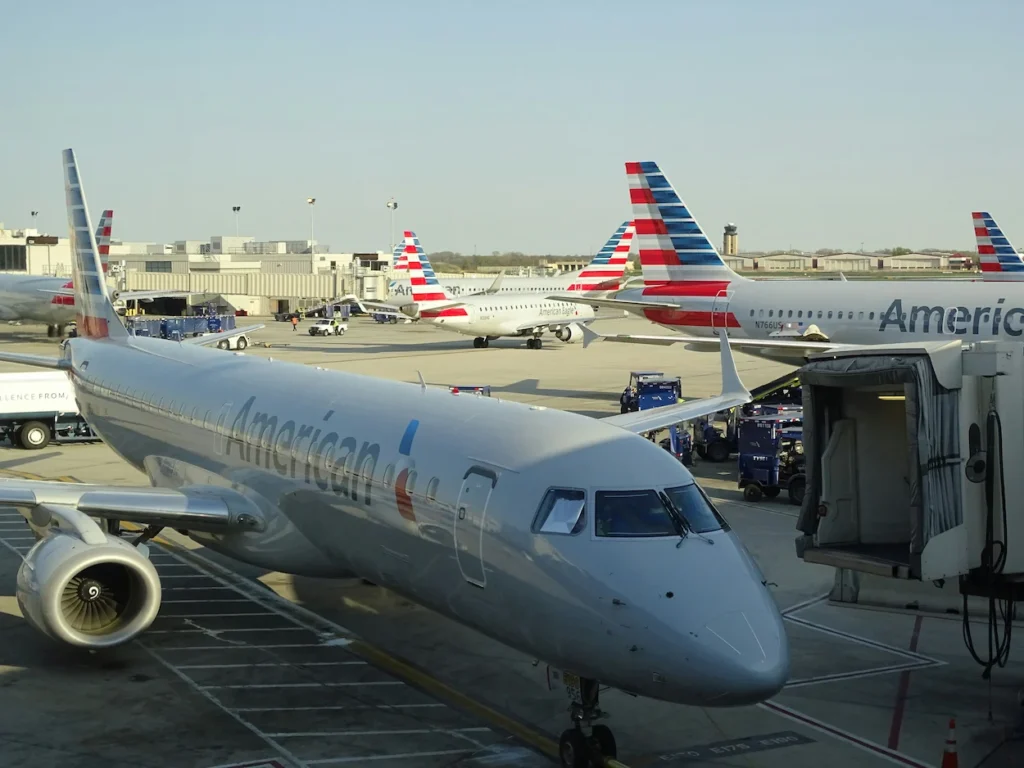 An American Airlines Embraer 175 passenger regional jet parked at an airport terminal gate