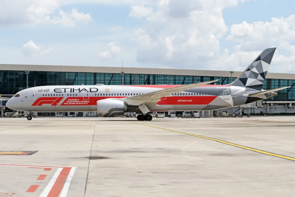 Etihad Airways Boeing 787 Dreamliner commercial passenger jet featuring the special Formula 1 livery on the airport runway