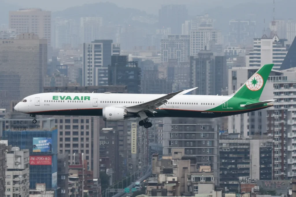 Side view of an EVA Air Boeing 787-10 Dreamliner passenger airplane with landing gear extended flying low