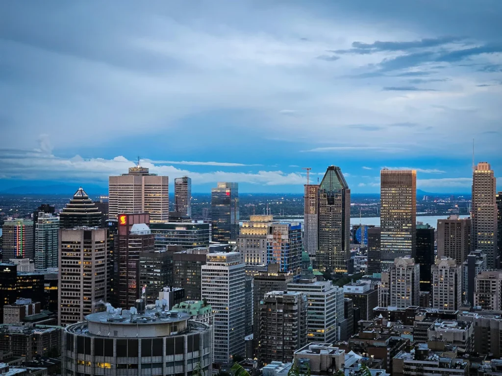 Montreal skyline and downtown skyscrapers under a blue and cloudy dusk sky