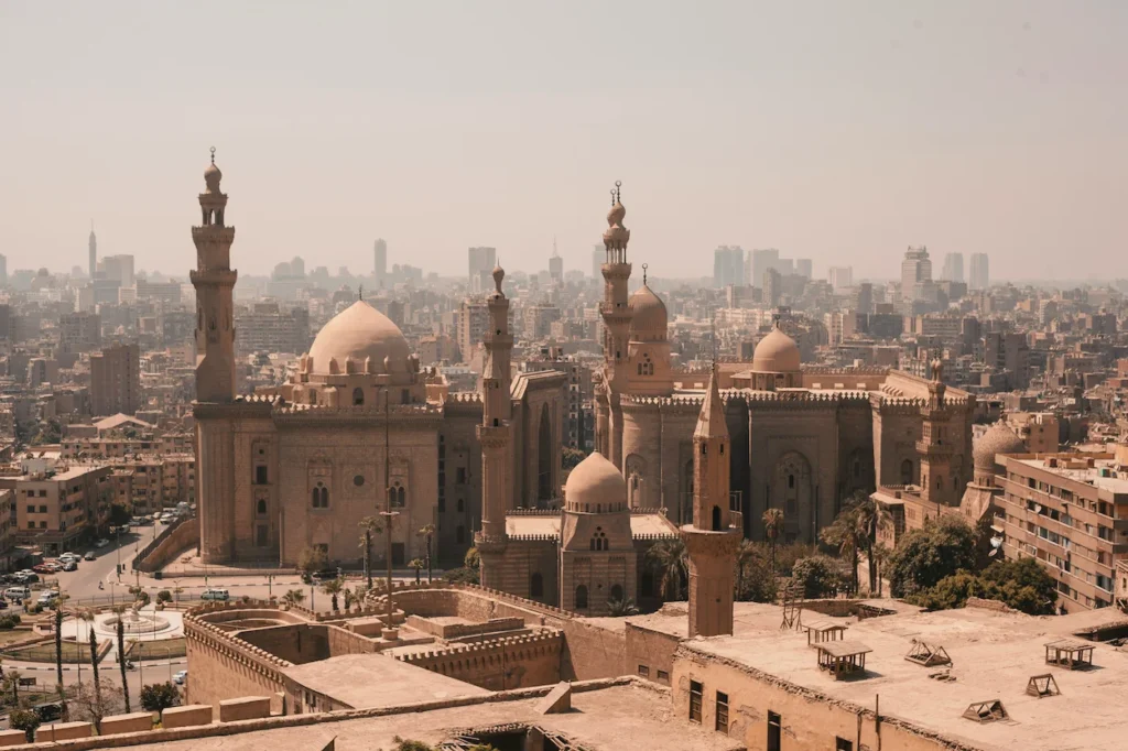 Mosque-Madrasa of Sultan Hasan and Al-Rifa'i Mosque overlooking the Cairo city skyline