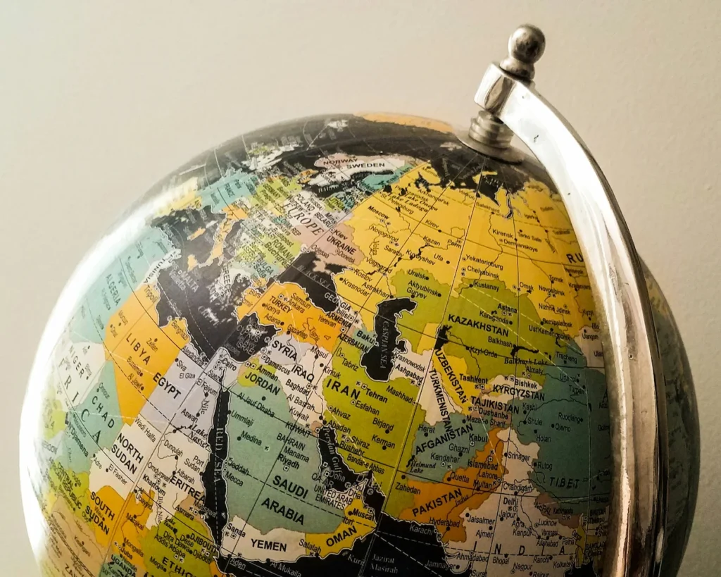 Close-up of a silver metallic desktop globe showing a map of the Middle East, Central Asia, and East Africa