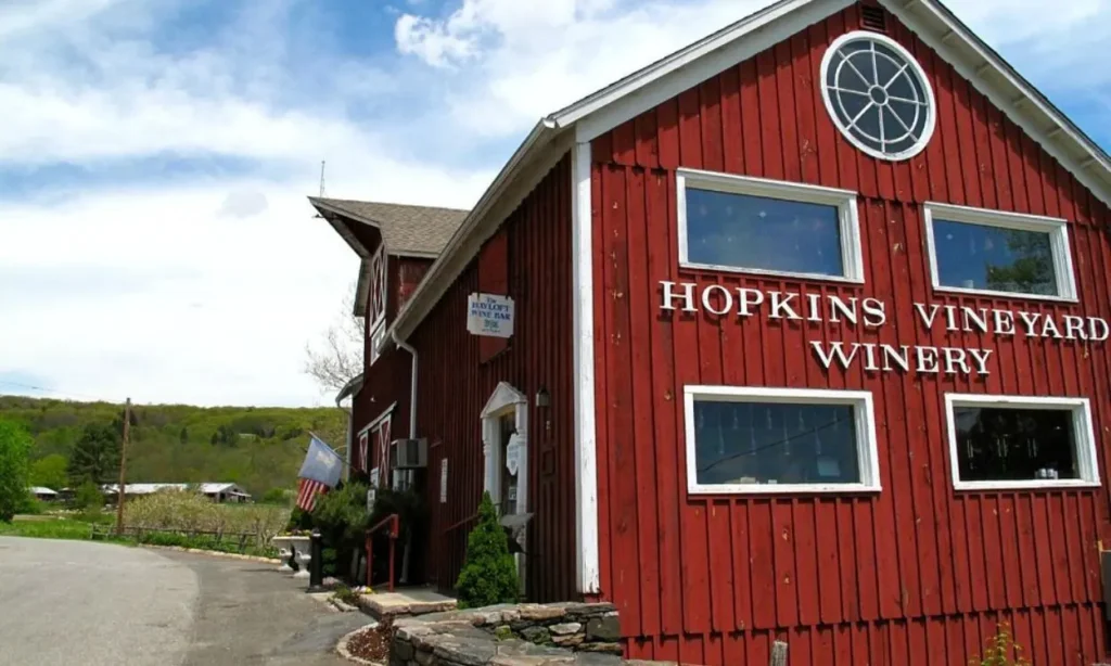 Red wooden barn building with white trim and signage for Hopkins Vineyard Winery on The Connecticut Wine Trail.