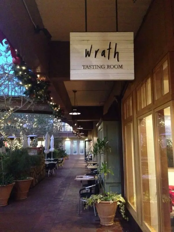 Outdoor seating area and sign for Wrath Wines Tasting Room.
