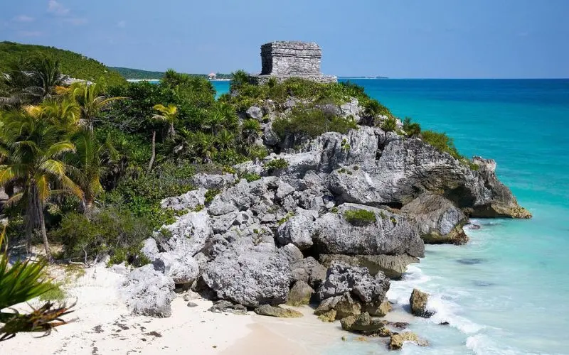 A small stone temple overlooks the turquoise sea at Tulum.