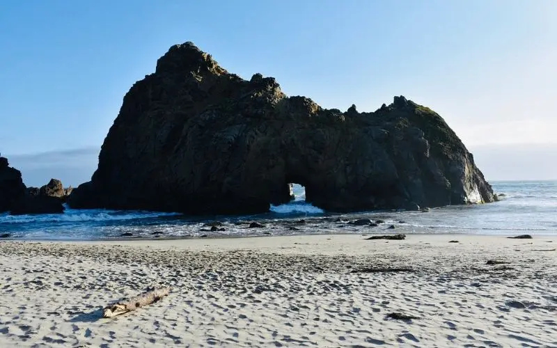 Large rock with a natural archway at Keyhole Arch on Pfeiffer Beach.