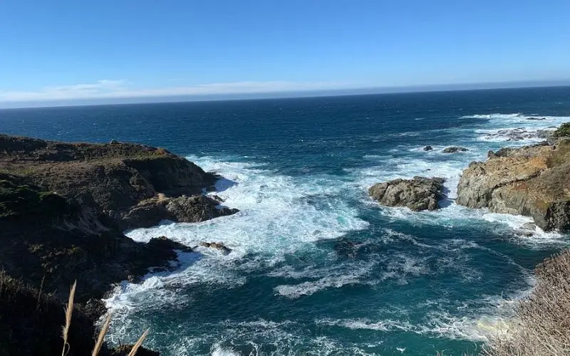 Waves crashing against cliffs at Julia Pfeiffer Burns State Park.