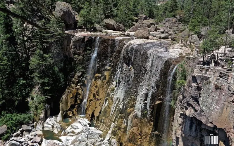 Tall waterfalls cascade down cliffs in Copper Canyon.
