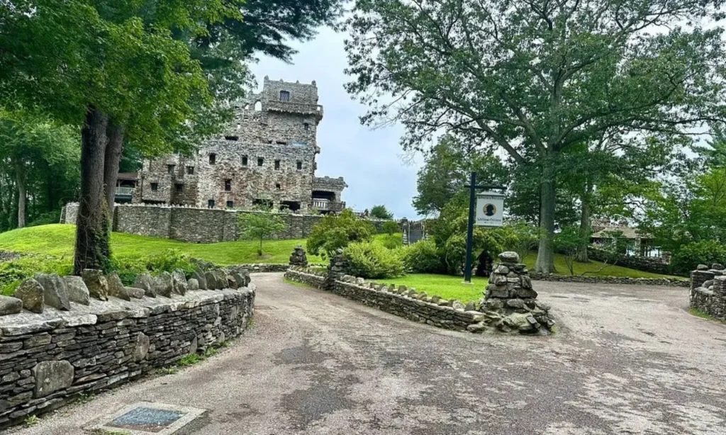 Stone castle surrounded by trees and stone walls at Gillette Castle State Park.