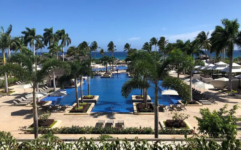 Large pool area with palm trees at Hyatt Ziva Rose Hall in Jamaica.