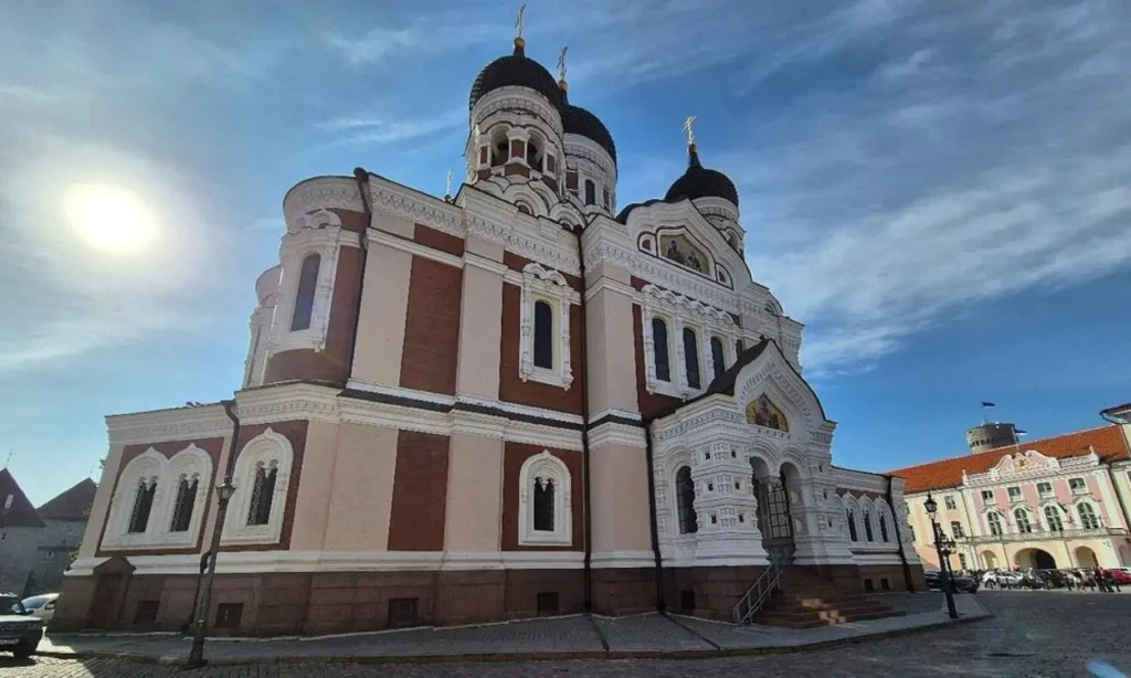 Alexander Nevsky Cathedral shines under the sun with its ornate domes and white details.