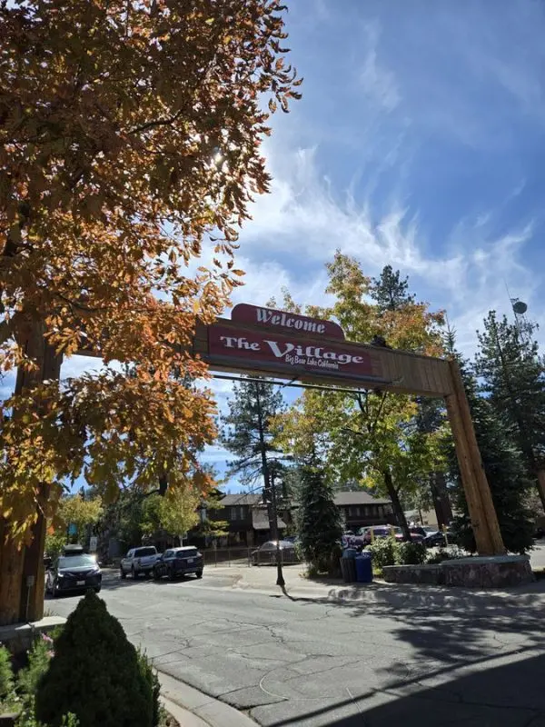 The wooden entrance sign welcomes visitors to The Village in Big Bear Lake.