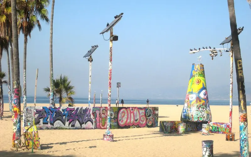 Colorful graffiti-covered walls and poles at the Venice Art Walls.