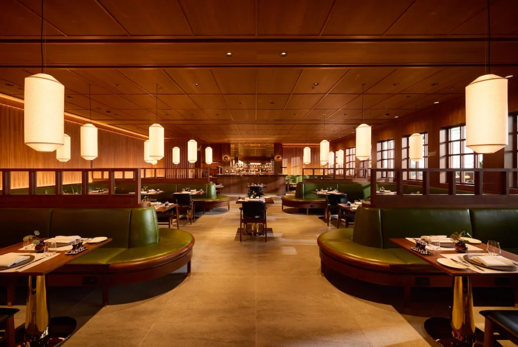 Cathay Pacific First Class Lounge dining room with green booths and warm wood paneling