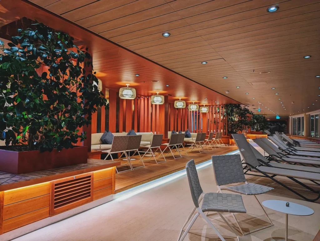 Chase Sapphire Lounge relaxation room with rows of lounge chairs and warm wooden panels