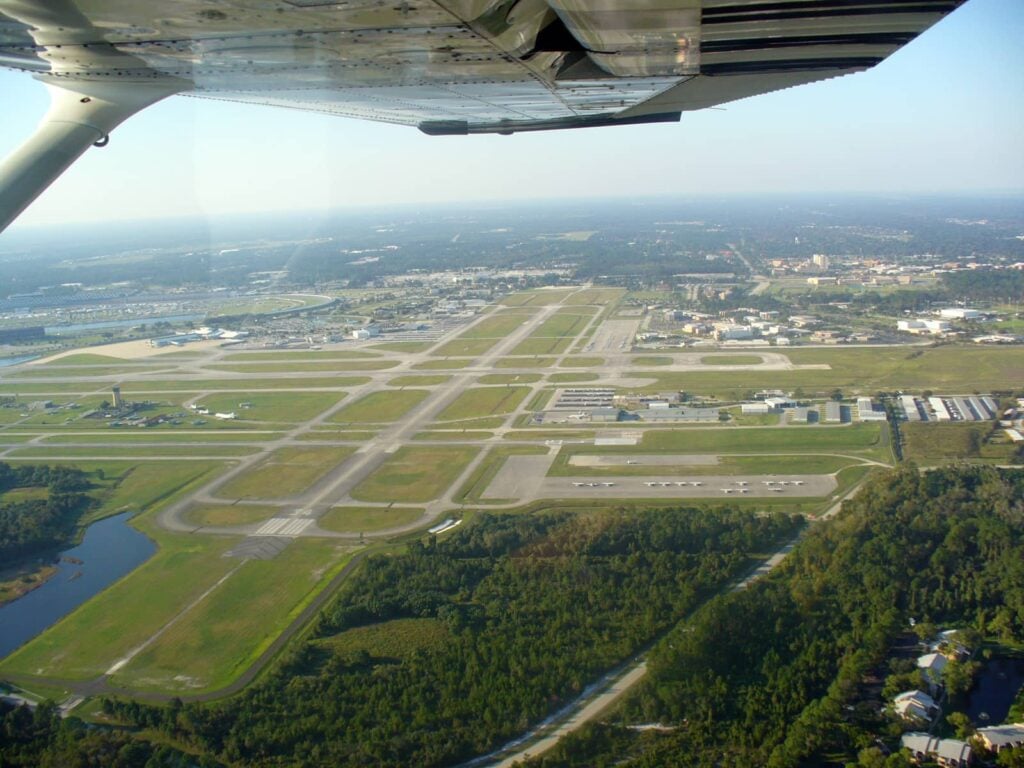 An aerial view of Daytona Beach International Airport from under the wing of a small commuter plane