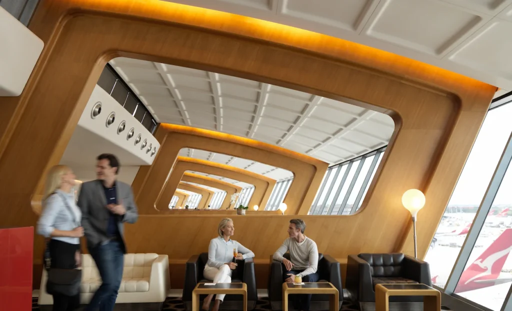 People sitting in the Qantas First Lounge at Sydney Airport
