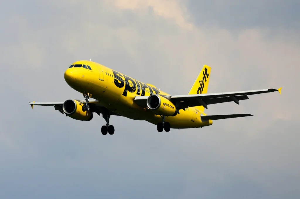 Spirit Airlines Airbus A320 passenger airplane flying with landing gear extended