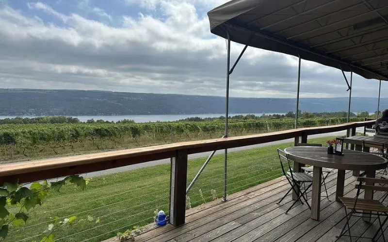Outdoor seating at Dr. Konstantin Frank Winery overlooks vineyard rows and the lake.