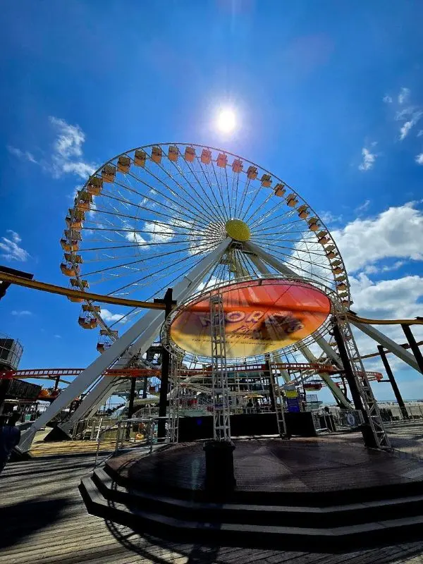 A sunny day at Morey’s Piers with a large Ferris wheel towering over the boardwalk.