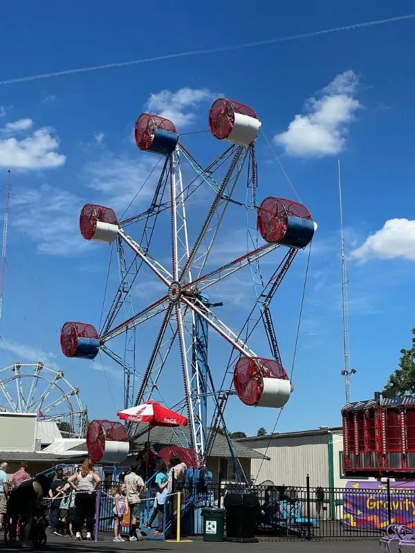Bright red and white Ferris wheel at Oaks Amusement Park.