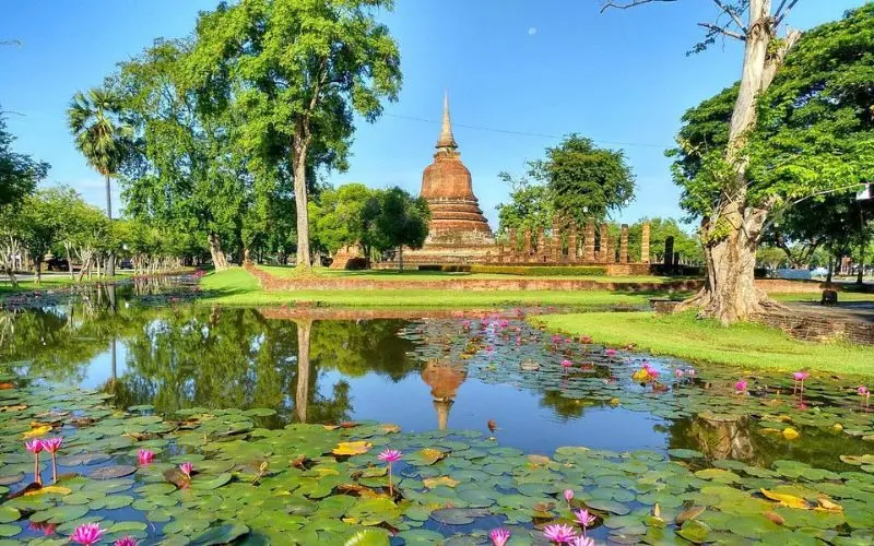 A brick stupa and lotus pond are seen at Sukhothai Historical Park.